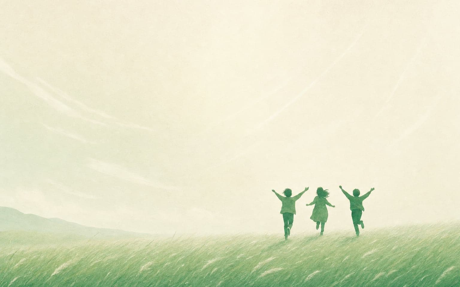 Three people running with arms raised across a windswept meadow