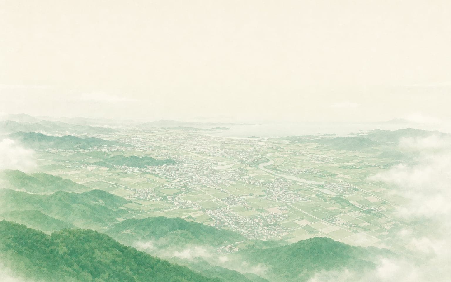 A hazy town and hills seen from the height of a kite